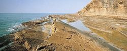 A slot cut at the bottom of a cliff, usually at the back of a wave-cut platform, formed by wave action eroding the base of the cliff.