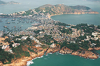 A narrow ridge of sand that connects an island with the mainland, or that connects two islands.